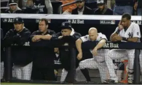  ?? JULIE JACOBSON — THE ASSOCIATED PRESS ?? New York Yankees pitcher Masahiro Tanaka, far left, Dellin Betances, second from left, Brett Gardner, second from right, and Chris Young, right, watch from the dugout against the Houston Astros during the ninth inning of the American League wild card...