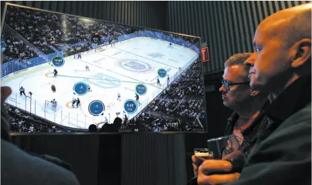  ?? AP PHOTO ?? People watch real-time puck and player tracking technology on display during an NHL hockey game between the Vegas Golden Knights and San Jose Sharks in Las Vegas on Thursday.