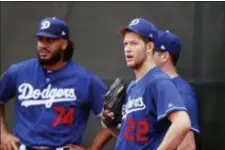  ?? CARLOS OSORIO — THE ASSOCIATED PRESS ?? Dodgers starting pitcher Clayton Kershaw (22) stands with relief pitcher Kenley Jansen (74) and starting pitcher Rich Hill during workouts at the team’s spring training baseball facility Wednesday in Glendale, Ariz.