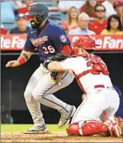  ?? John Cordes Associated Press ?? THE TWINS’ Sandy Leon is tagged out at the plate by Angels catcher Max Stassi in the third inning.