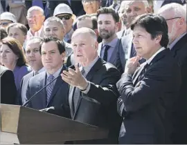  ?? Rich Pedroncell­i Associated Press ?? GOV. JERRY BROWN, center, Senate leader Kevin de León (D-Los Angeles), right, and others hope to extend cap and trade through a supermajor­ity vote.