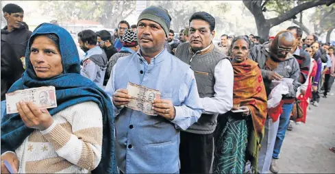  ?? Picture: EPA ?? CASHING IN: Indians line up to deposit old Indian rupee notes, which they are holding, outside the Reserve Bank of India in New Delhi