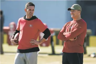  ?? Tony Avelar / Associated Press ?? “We’re going to have to get creative,” says 49ers general manager John Lynch (right), with head coach Kyle Shanahan, in managing the shrinking NFL salary cap over the next three seasons.