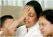  ?? ?? THE UNSTOPPABL­E TEAR: As Sanath Nishantha’s wife speaks to the President, his only son touchingly wipes away the tears falling from his mother’s eyes