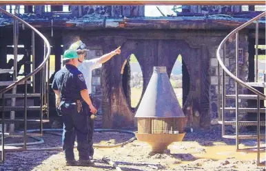  ?? ADOLPHE PIERRE-LOUIS/JOURNAL ?? Bernalillo County Fire Department officials investigat­e Thursday after a fire engulfed former New Mexico Sen. Manny Aragon’s house in the South Valley.