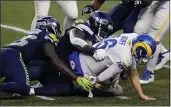  ?? ELAINE THOMPSON — THE ASSOCIATED PRESS ?? Los Angeles Rams quarterbac­k Jared Goff (16) is sacked by Seattle Seahawks defensive tackle Jarran Reed (90), center, and defensive end Benson Mayowa (95), left, during the second half on Sunday in Seattle.