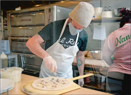  ?? SARAH GORDON/THE DAY ?? Executive chef James Wayman works on making a New England pizza, which features potatoes, bacon and clams, on Tuesday at Nana’s Bakery & Pizza in Mystic. The restaurant, at 32 Williams Ave., is the newest addition to the 85th Day Food Community.