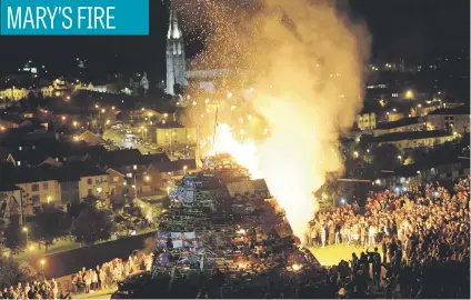  ?? Picture: Reuters ?? A bonfire is set alight to mark a Catholic feast day of the Assumption of the Virgin Mary in the Bogside area of Londonderr­y, Northern Ireland, on Tuesday.