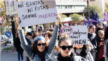  ?? | EPA ?? A WOMAN raises a placard reading: ‘Neither saints nor whores, we are women’ during one of the countrywid­e demonstrat­ions held on the Internatio­nal Day for the Eliminatio­n of Violence Against Women, in Majorca, Spain, yesterday. Up to 44 women have died in Spain, killed by their partners this year, which brought the number of cases to 972 of women killed in the country since statistics started to study violence against women in 2003.