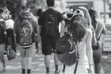  ?? Lynne Sladky / Associated Press ?? Students head to class at Miami Dade College in 2018 in Miami. Many parents have borrowed to help their kids pay for college.