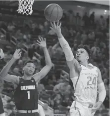  ?? John Locher / Associated Press ?? Oregon’s Dillon Brooks shoots against Cal’s Ivan Rabb during the first half of their Pac-12 tournament game in Las Vegas.