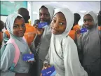  ?? ?? Middle: Students display travel cards for the Blue