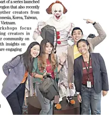  ??  ?? FACEBOOK APAC executives with Prince de Guzman wearing a full Pennywise make-up and costume.