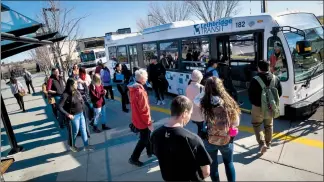  ?? @IMartensHe­rald Herald photo by Ian Martens ?? Riders prepare to board a transit bus Monday on the Aperture Drive loop at the University of Lethbridge. A second round of changes are being introduced as a response to a ridership increase, following the successful introducti­on of the new UPass.