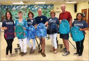  ?? SUBMITTED PHOTO ?? Longwood Rotary Club members and volunteers display some of the backpacks that were distribute­d to underprivi­leged children in Chester County.