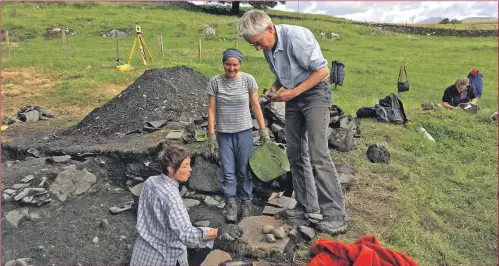  ??  ?? Archaeolog­ist Dr Clare Ellis, right, examines an artefact from the nave tower as volunteers dig.