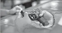  ?? Ricardo Ramirez Buxeda/orlando Sentinel/tns ?? A customer looks at a handgun at the Kissimmee, Florida, location of The Armories on Dec. 31, 2020. From 2019 to 2020, homicides involving firearms rose 35% to 6.1 per 100,000 people, a new CDC report says. (Ricardo Ramirez Buxeda/orlando Sentinel/tns)