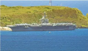  ?? RICK CRUZ/AP ?? The risks of carrying out the military’s mission amid the pandemic became clear when hundreds of sailors aboard the nuclear-powered aircraft carrier USS Theodore Roosevelt were stricken with the coronaviru­s.