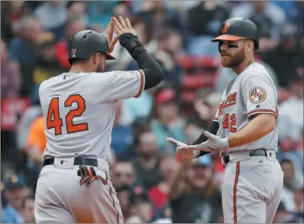  ?? MICHAEL DWYER - THE ASSOCIATED PRESS ?? Baltimore Orioles’ Chris Davis, right, celebrates his two-run home run that also drove in Renato Nunez, left, during the eighth inning of a baseball game against the Boston Red Sox in Boston, Monday, April 15, 2019.