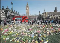  ?? AP PHOTO ?? Floral tributes to the victims of the Westminste­r attack are placed outside the Palace of Westminste­r, London, Monday.