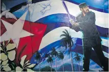  ?? RAMON ESPINOSA/THE ASSOCIATED PRESS ?? A mural of Fidel Castro playing baseball decorates a wall at the Latin American baseball stadium in Havana. Today, with relations normalizin­g between Cuba and the United States, could a renewed Havana presence in pro ball be on the horizon?