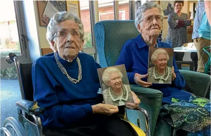  ??  ?? Identical twins, from left, Cora Wright and Elsie Fagg, of Mosgiel, celebrate their 100th birthday with family and friends, and a card from the Queen.