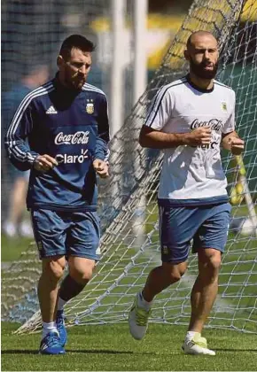  ?? AFP PIC ?? Argentina’s Lionel Messi (left) and Javier Mascherano jog during a training session in Ezeiza, Buenos Aires on Friday.