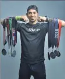  ?? SANCHIT KHANNA/HT PHOTO ?? Amit Kadian poses with his haul of medals.