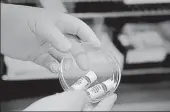  ?? AFP ?? ■
A scientist holds samples of the potential oral vaccine for the Covid-19 in Burgess Hill south east England.