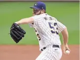  ?? GETTY IMAGES ?? Brewers starter Brandon Woodruff makes a pitch in the first inning against the Cubs at Miller Park on Friday.