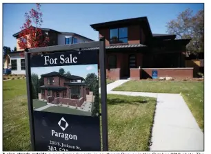  ?? (AP/David Zalubowski) ?? A sign stands outside a new home for sale in southeast Denver in this October 2019 photo. The coronaviru­s has put the brakes on once-booming housing markets across the United States.