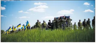  ?? (AP/Francisco Seco) ?? Ukrainian soldiers carry the coffin of Volodymyr Losev, 38, on May 16 during his funeral in Zorya Truda in the Odesa region of Ukraine. The 38-year-old Ukrainian volunteer soldier was killed May 7 when the military vehicle he was driving ran over a mine in eastern Ukraine.