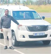  ??  ?? Mfundo Ndlovu of Amasondo Motors with one of the vehicles the dealership sells