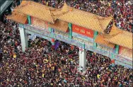  ?? BULLIT MARQUEZ / AP ?? The procession of the Feast of the Black Nazarene, a popular religious festival in the Philippine­s, passes under the landmark arch of Binondo, Manila’s Chinatown, during last year’s celebratio­n.