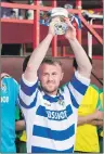  ?? Photo: Neil Pateson ?? SILVERWARE: Newtonmore captain Martin Ivil holds aloft
the Strathdear­n Cup