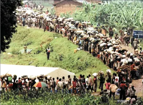  ?? Picture: John Parkin ?? GOING HOME: Rwandan Hutu refugees stand in line at the Mukungwa transit camp waiting for transport to Kigali. Thousands of refugees left camps in the DRC and returned to their home country.