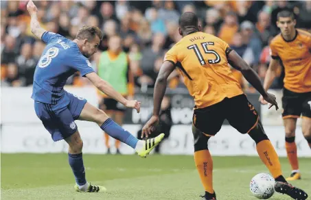  ??  ?? Joe Ralls hits the opening goal as Championsh­ip leaders Cardiff kept their 100% record by beating Wolves 2-1 at Molineux on Saturday.