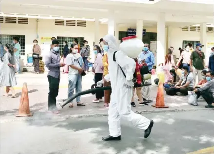  ?? HONG MENEA ?? A health worker sprays disinfecta­nt at Calmette Hospital in Phnom Penh on Monday.