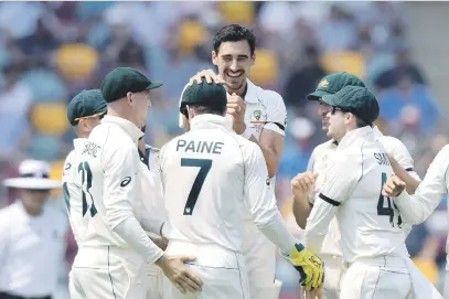  ?? Picture: Getty Images ?? DOMINANT. Australian speedster Mitchell Starc (centre) celebrates with team-mates after taking the wicket of Pakistan’s Haris Sohail during the first day of the first Test at The Gabba yesterday.