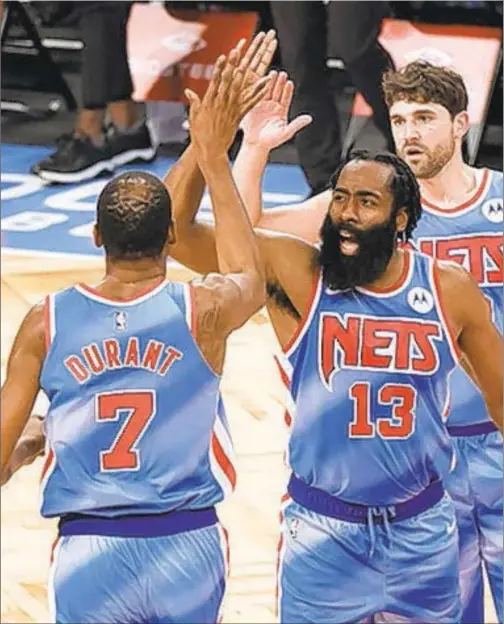  ?? GETTY ?? Kevin Durant and James Harden high-five during Saturday night’s Nets victory over Orlando as they launch new era of Nets basketball.