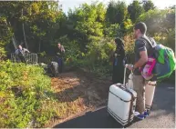  ?? GEOFF ROBINS / AFP VIA GETTY IMAGES FILES ?? Migrants prepare to cross into Canada illegally at the Quebec border in 2017. Prime Minister Justin Trudeau
hopes to attract 421,000 newcomers by 2023.