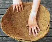  ?? Getty Images ?? Place a liner or moss in a hanging basket, then add soil mixed for containers.