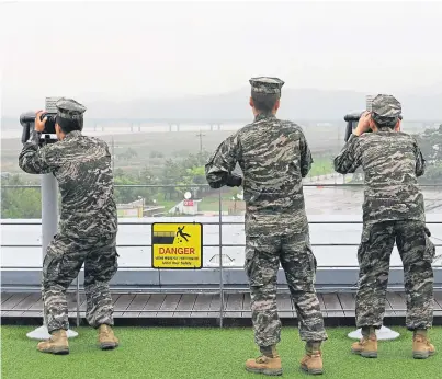  ?? Picture: AP. ?? South Korean Marines look towards North Korea near the border yesterday.