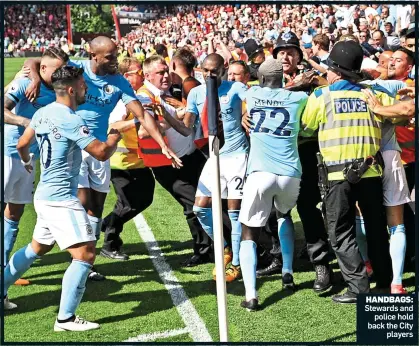  ??  ?? HANDBAGS: Stewards and police hold back the City players