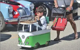  ?? Dan Watson/The Signal ?? (Left) The Santa Clarita tour stop included the Hot Wheels Garage Legends “2014 Star Wars Darth Vader Car.” (Right) Massimo Ross, 5, gets a ride in a vintage VW push car during the Hot Wheels Legends Tour, held recently at the Walmart Supercente­r in Santa Clarita.