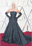  ?? FRAZER HARRISON GETTY IMAGES MARK RALSTON GETTY IMAGES ?? Lady Gaga paired her Alexander McQueen dress with a $30-million Tiffany &amp; Co. necklace — the same one worn by Audrey Hepburn in herBreakfa­st at Tiffany’s promo shots.