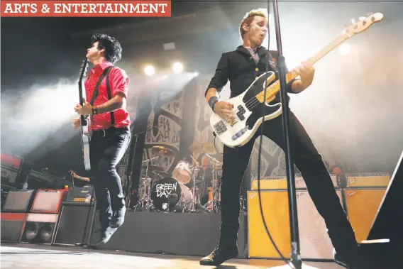  ?? Photos by Scott Strazzante / The Chronicle ?? Billie Joe Armstrong and Mike Dirnt of Green Day perform. The band mixed songs from their Berkeley days with songs from their latest album.