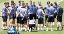  ??  ?? Real Madrid's head coach Zinedine Zidane, right, speaks with his players during a training session at a media open day in Madrid Tuesday. Real Madrid will play Juventus Saturday in the Champions League final in Cardiff. (AP)