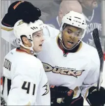  ?? — Associated Press file photo ?? Andrew Gordon (41), shown being congratula­ted by Anaheim Ducks’ teammate Devante Smith-Pelley after scoring a goal during the 2011-12 season, has played 55 NHL games with Anaheim, Washington Capitals and Vancouver Canucks.