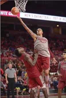 ?? NWA Democrat-Gazette/Andy Shupe ?? BACK IN ACTION: Arkansas forward Dustin Thomas (center) reaches to score as he collides forward Adrio Bailey during the Red-White game on Oct. 20, 2017, in Bud Walton Arena. Thomas, who was suspended for the first five games of the season, has been...
